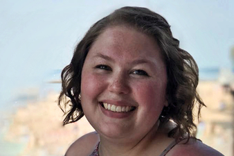 Brittani posing near a beach